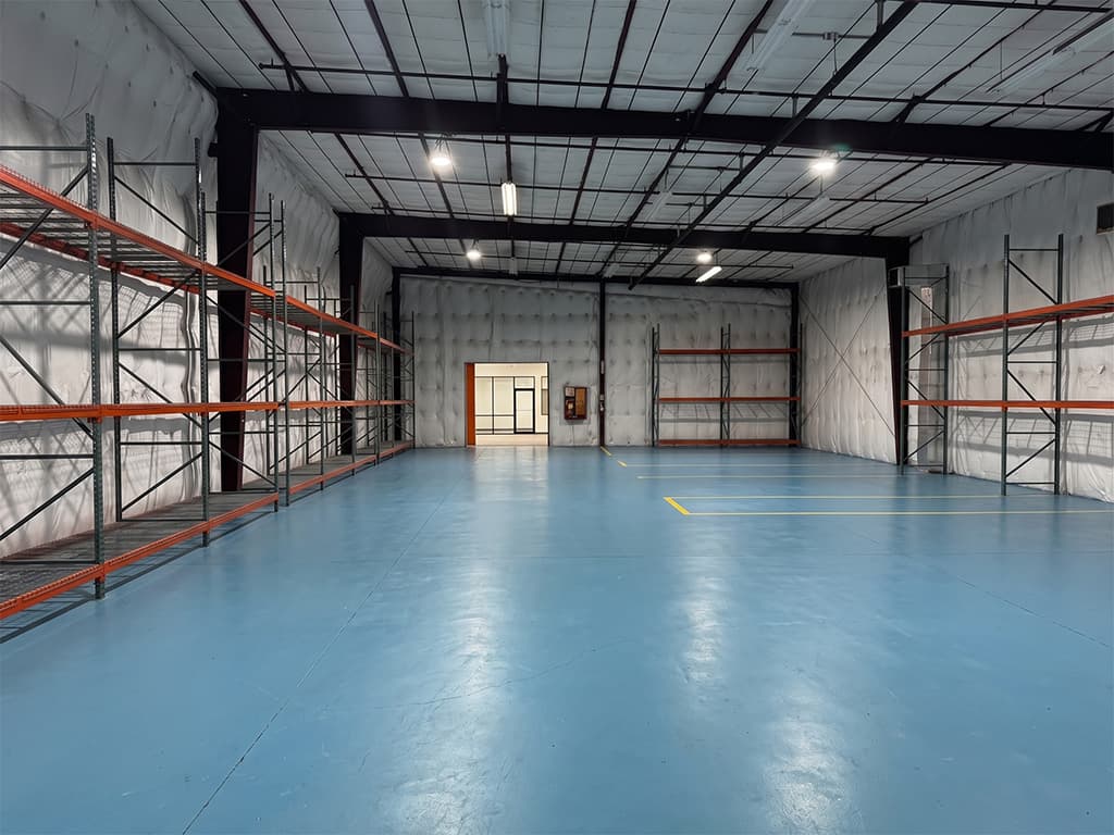 Warehouse interior with partition opening to office space at 15 Hargrove Grade